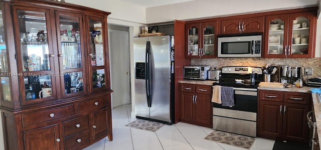 8111 SW 205th St, Cutler Bay, FL 33189 - kitchen with light countertops, appliances with stainless steel finishes, glass insert cabinets, and tasteful backsplash
