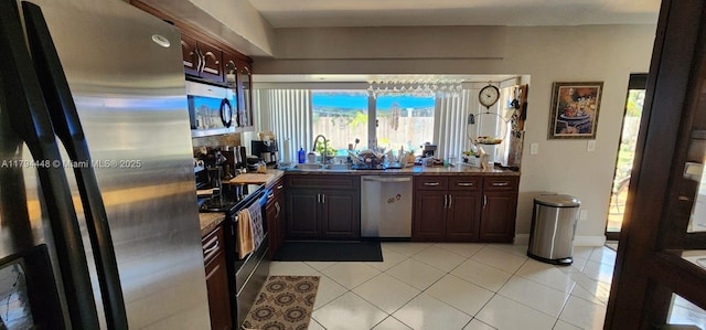 8111 SW 205th St, Cutler Bay, FL 33189 - kitchen featuring light tile patterned flooring, dark brown cabinetry, appliances with stainless steel finishes, and a sink
