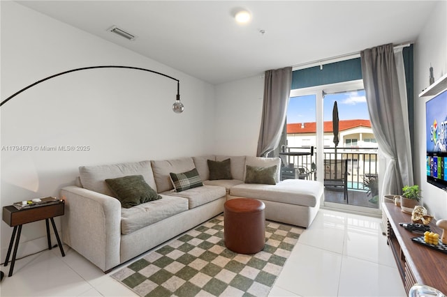 living area featuring visible vents and light tile patterned floors