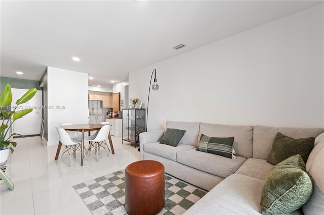 living room featuring light tile patterned floors, recessed lighting, and visible vents