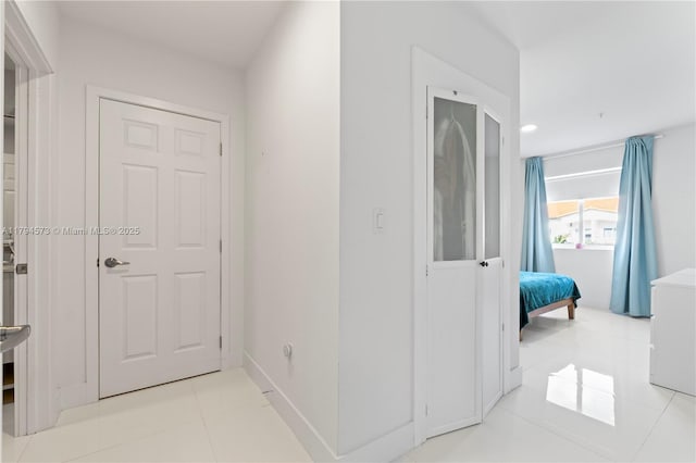 hall featuring recessed lighting and light tile patterned floors