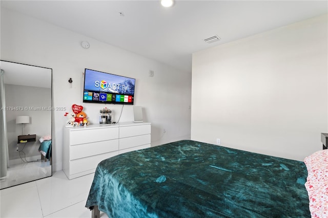 bedroom with light tile patterned floors and visible vents