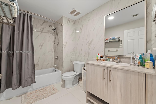 full bath with visible vents, vanity, shower / bath combo with shower curtain, toilet, and tile walls