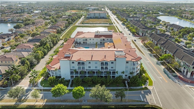 drone / aerial view with a residential view and a water view