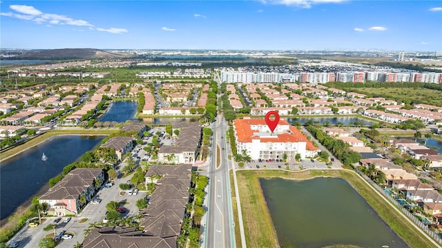 birds eye view of property with a water view and a residential view
