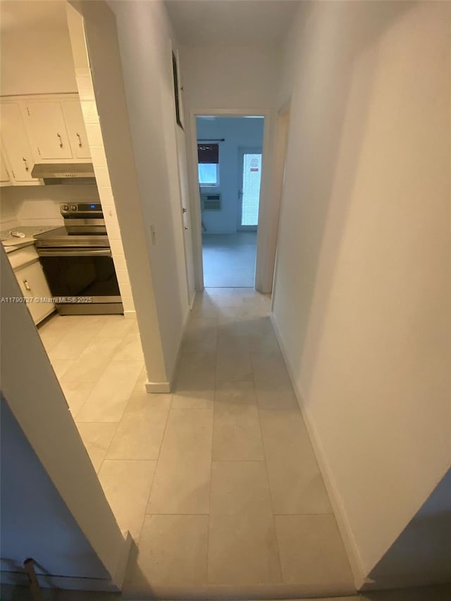 600 Layne Unit 216, Hallandale Beach, FL 33009 - corridor featuring baseboards and light tile patterned flooring