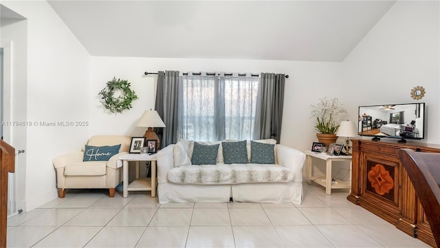 living area featuring tile patterned flooring and vaulted ceiling