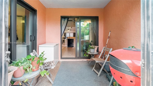 doorway to property featuring stucco siding and a balcony