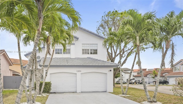 12894 SW 60th Ter, Miami, FL 33183 - view of front of property featuring concrete driveway, a tiled roof, a garage, and stucco siding