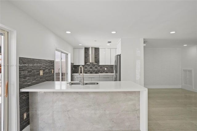12894 SW 60th Ter, Miami, FL 33183 - kitchen featuring visible vents, freestanding refrigerator, modern cabinets, wall chimney range hood, and white cabinetry