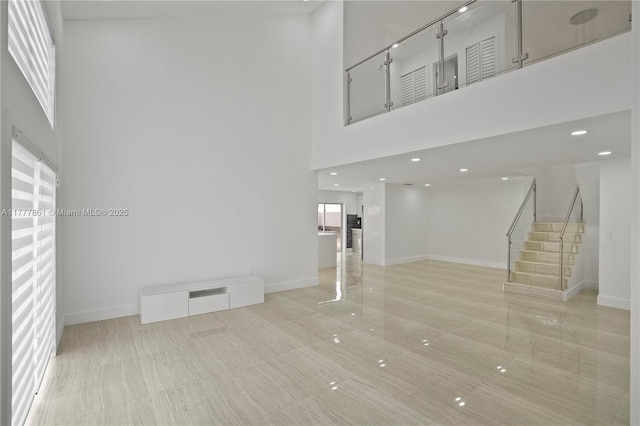 12894 SW 60th Ter, Miami, FL 33183 - unfurnished living room with baseboards, stairs, and a towering ceiling