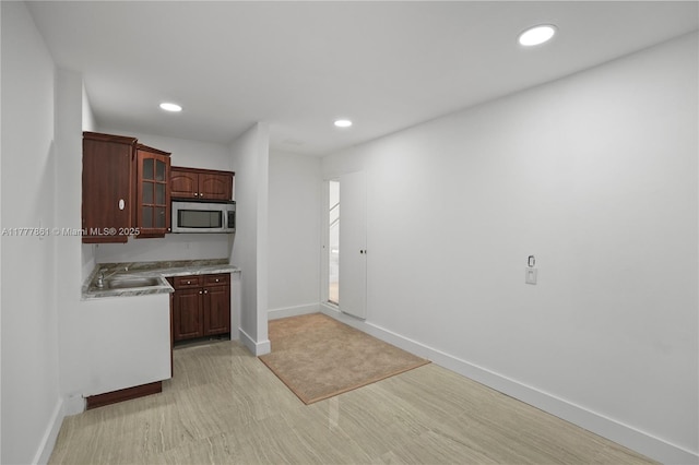 12894 SW 60th Ter, Miami, FL 33183 - kitchen with glass insert cabinets, light wood-type flooring, recessed lighting, light countertops, and stainless steel microwave
