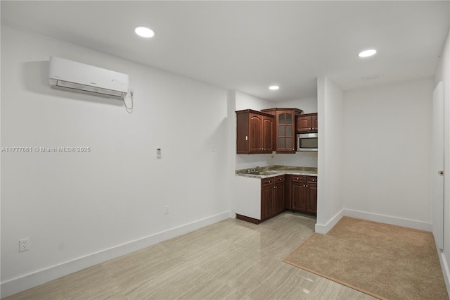12894 SW 60th Ter, Miami, FL 33183 - kitchen featuring glass insert cabinets, baseboards, an AC wall unit, recessed lighting, and stainless steel microwave