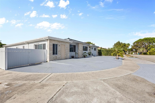 9365 SW 44th St, Miami, FL 33165 - view of front of home featuring fence and stone siding