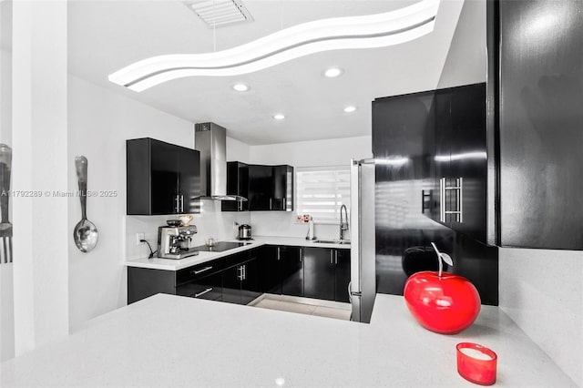 9365 SW 44th St, Miami, FL 33165 - kitchen featuring wall chimney range hood, light countertops, black electric stovetop, dark cabinets, and recessed lighting