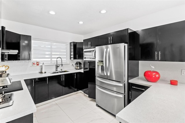 9365 SW 44th St, Miami, FL 33165 - kitchen with recessed lighting, light countertops, dark cabinetry, a sink, and stainless steel appliances