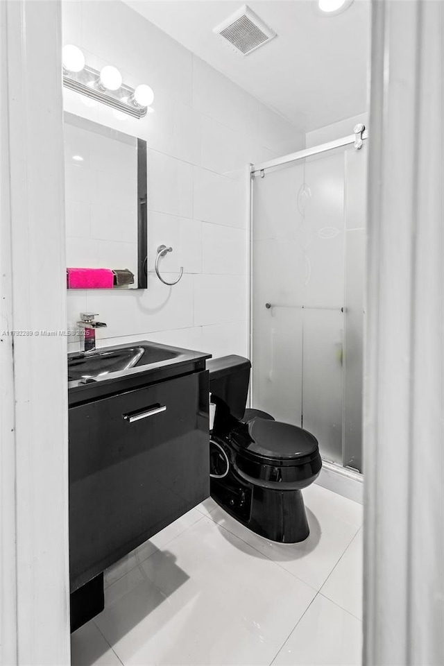 9365 SW 44th St, Miami, FL 33165 - bathroom featuring visible vents, tile walls, a shower stall, vanity, and toilet