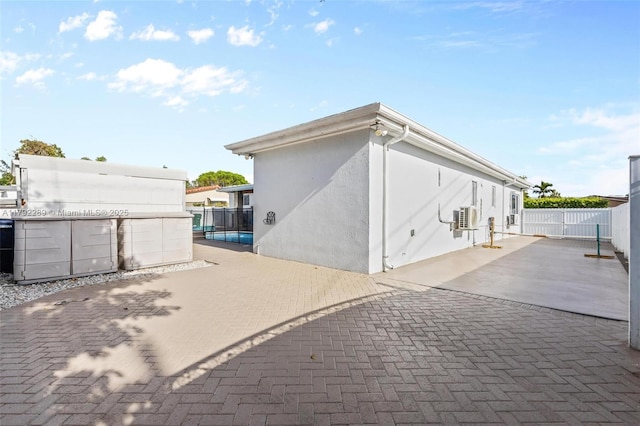 9365 SW 44th St, Miami, FL 33165 - back of property featuring fence, a patio, and stucco siding