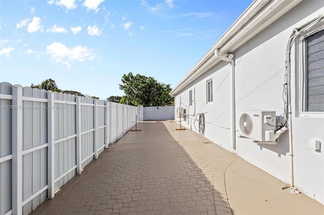 9365 SW 44th St, Miami, FL 33165 - view of property exterior with stucco siding, ac unit, fence, and a patio area