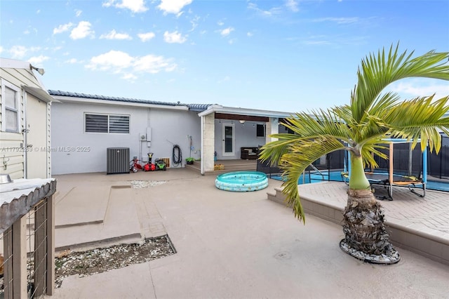 9365 SW 44th St, Miami, FL 33165 - rear view of house with a tiled roof, a patio, central air condition unit, and stucco siding
