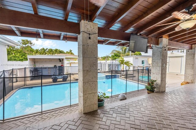 9365 SW 44th St, Miami, FL 33165 - view of swimming pool featuring a fenced backyard, a fenced in pool, a ceiling fan, a patio area, and exterior kitchen