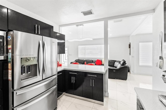 9365 SW 44th St, Miami, FL 33165 - kitchen featuring dark cabinetry, stainless steel fridge, marble finish floor, and light countertops