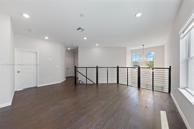 4317 Ficus St, Hollywood, FL 33021 - empty room featuring an inviting chandelier, recessed lighting, dark wood-type flooring, and visible vents
