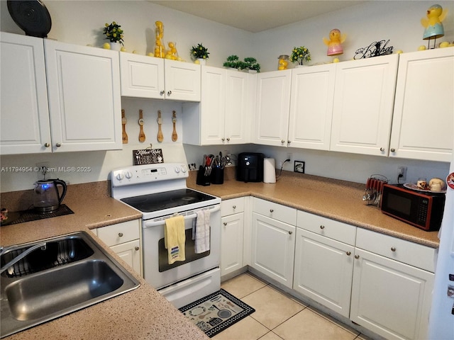 kitchen with white electric range oven, white cabinets, a sink, and black microwave