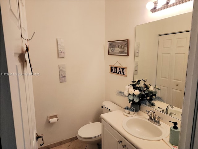 half bath featuring toilet, tile patterned flooring, and vanity