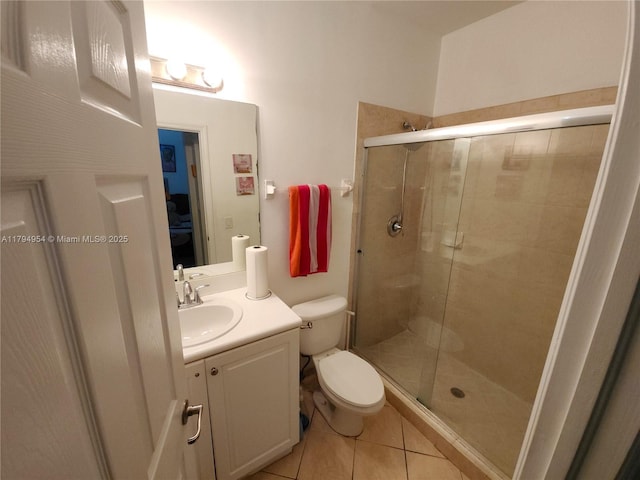 bathroom featuring vanity, toilet, a shower stall, and tile patterned floors