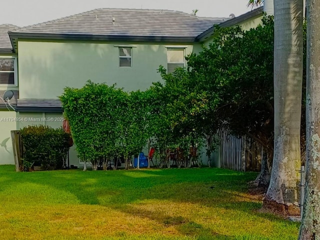 exterior space featuring a yard and stucco siding