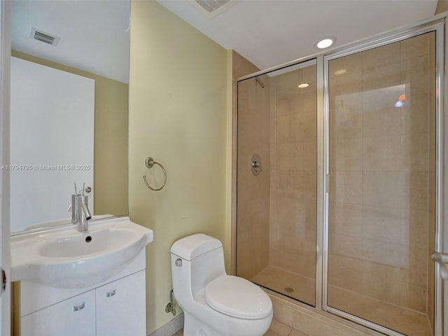 bathroom with toilet, visible vents, a shower stall, and vanity