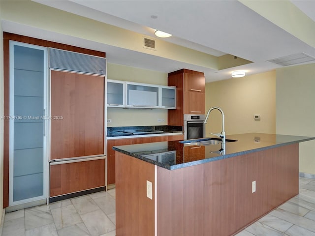 17201 Collins Ave Unit 1704, Sunny Isles Beach, FL 33160 - kitchen featuring oven, a sink, marble finish floor, visible vents, and paneled fridge