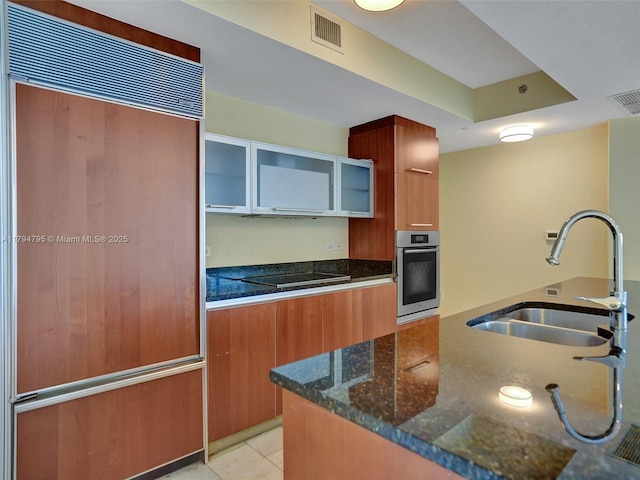 17201 Collins Ave Unit 1704, Sunny Isles Beach, FL 33160 - kitchen with oven, a sink, paneled refrigerator, visible vents, and modern cabinets