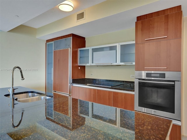 17201 Collins Ave Unit 1704, Sunny Isles Beach, FL 33160 - kitchen featuring oven, black electric stovetop, a sink, visible vents, and modern cabinets