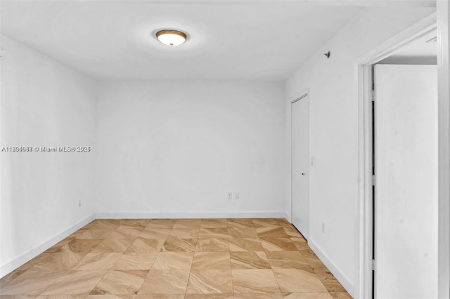 spare room with baseboards