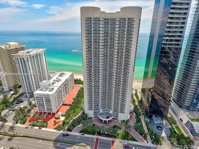 aerial view with a water view and a beach view