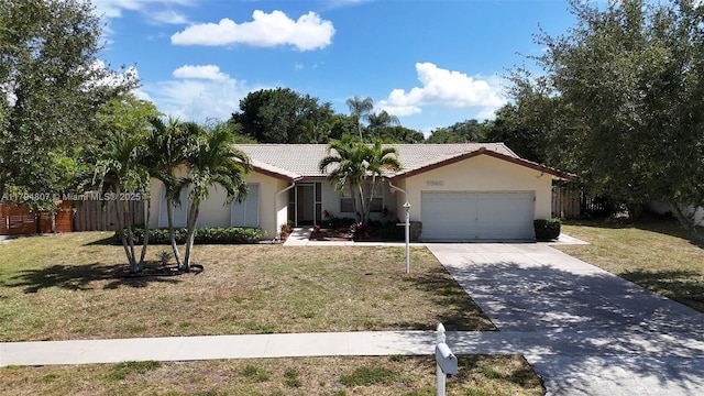 single story home with driveway, a tiled roof, fence, a garage, and stucco siding