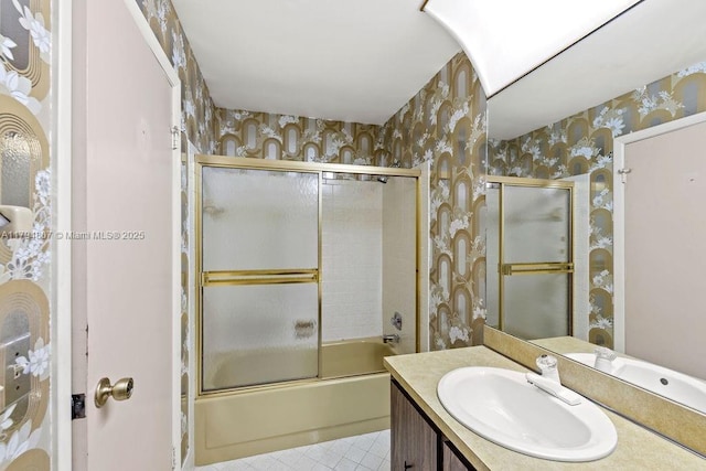 bathroom featuring wallpapered walls, tile patterned flooring, vanity, and shower / bath combination with glass door