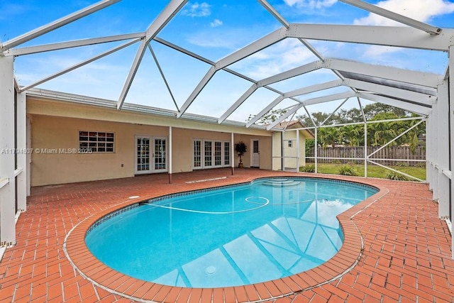 view of swimming pool featuring a patio area, french doors, a fenced in pool, and fence