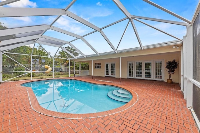 pool with a patio area, a lanai, and french doors