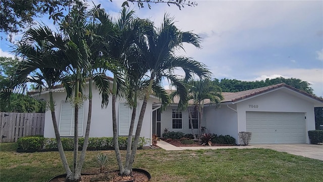 7640 NW 6th Ct, Plantation, FL 33324 - view of front of house with stucco siding, an attached garage, concrete driveway, and a tiled roof