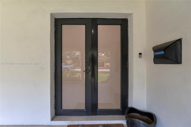 549 NE 12th Ave, Fort Lauderdale, FL 33301 - property entrance with stucco siding and french doors