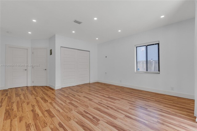 549 NE 12th Ave, Fort Lauderdale, FL 33301 - unfurnished bedroom featuring visible vents, a closet, light wood-style floors, baseboards, and recessed lighting