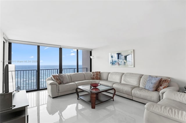 tiled living room with expansive windows, a water view, and a healthy amount of sunlight
