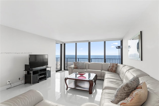 living room featuring baseboards, plenty of natural light, expansive windows, and tile patterned floors