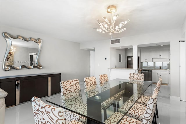 dining space with visible vents, decorative columns, and an inviting chandelier