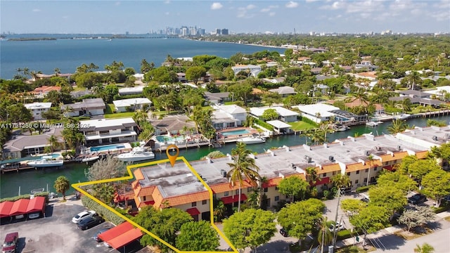 drone / aerial view with a water view and a residential view