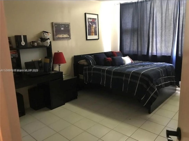 bedroom with light tile patterned floors