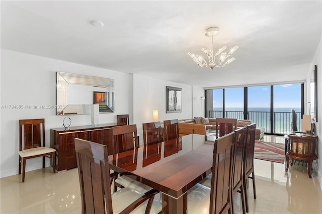 dining room featuring a chandelier, baseboards, light tile patterned floors, a water view, and expansive windows